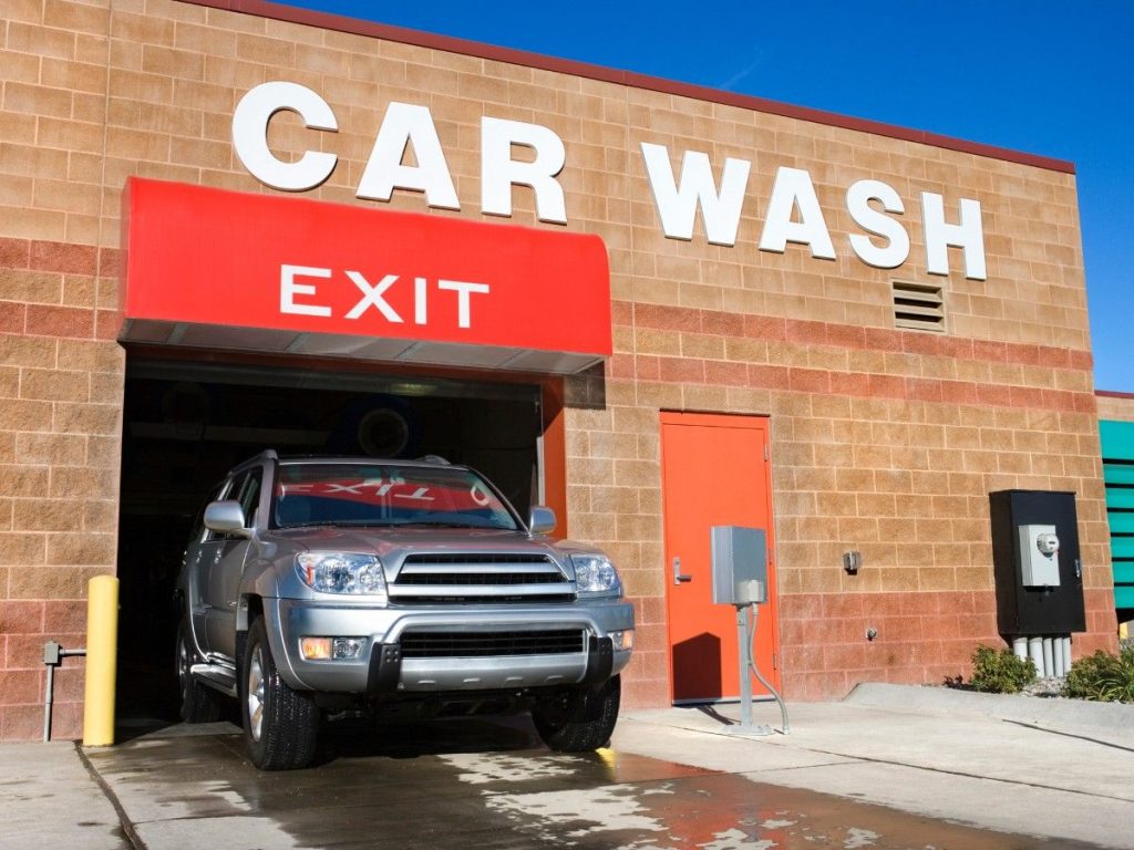 A customer's SUV leaving the bay of a car wash, demonstrating the convenience of our Car Wash Membership Plans Katy TX.