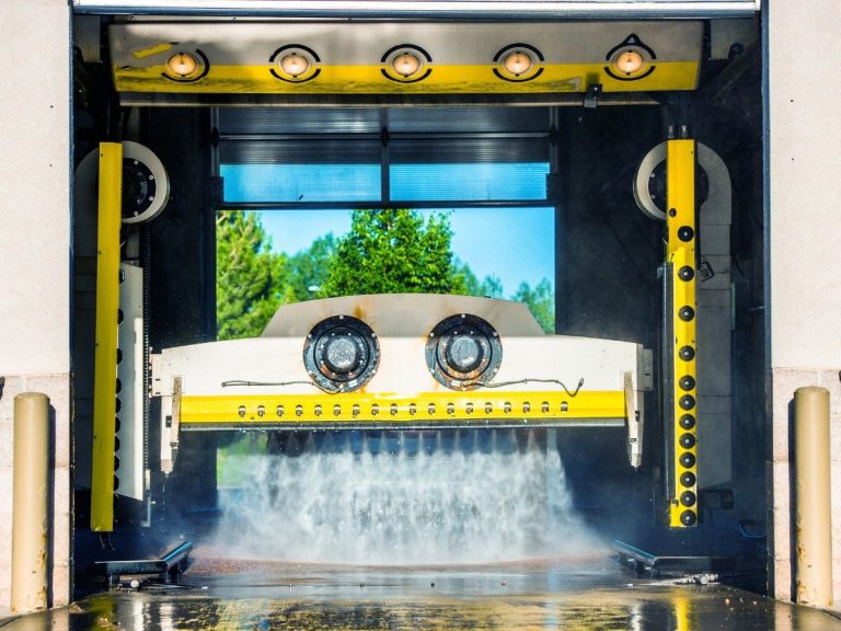 Car being washed by powerful water jets, part of an Unlimited Pet Wash Membership in Katy TX