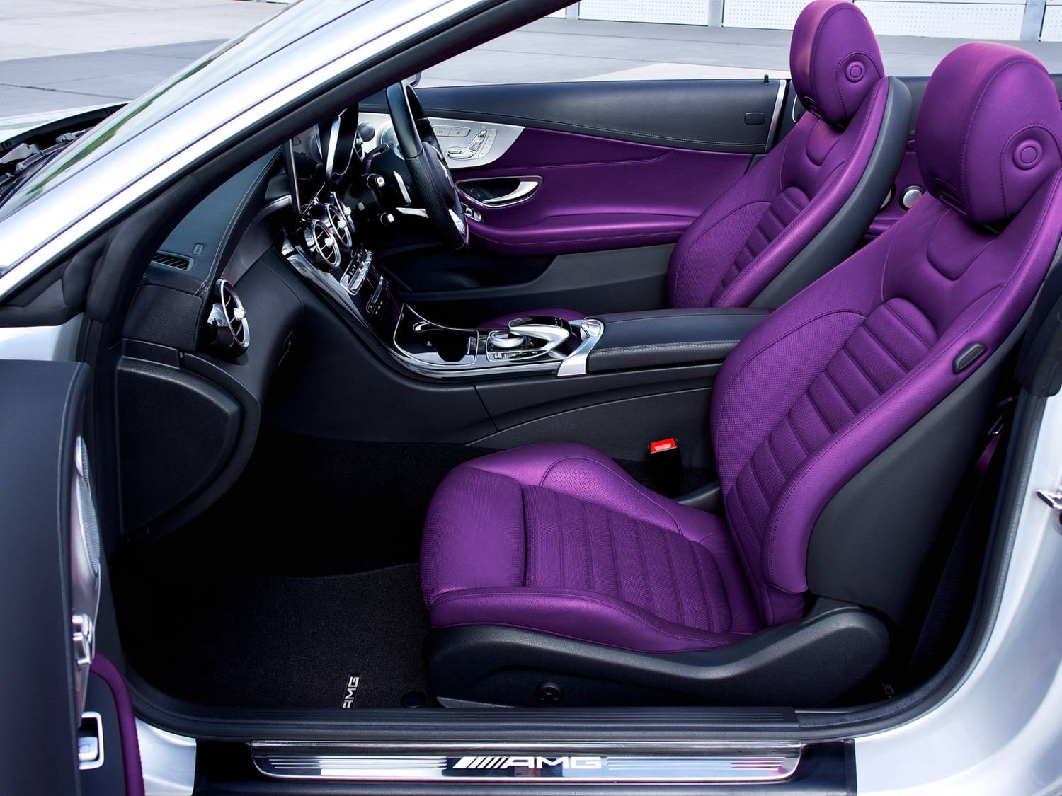 Vibrant purple leather seats in luxury AMG car interior cleaned at Drive-Thru Car Wash Katy TX.