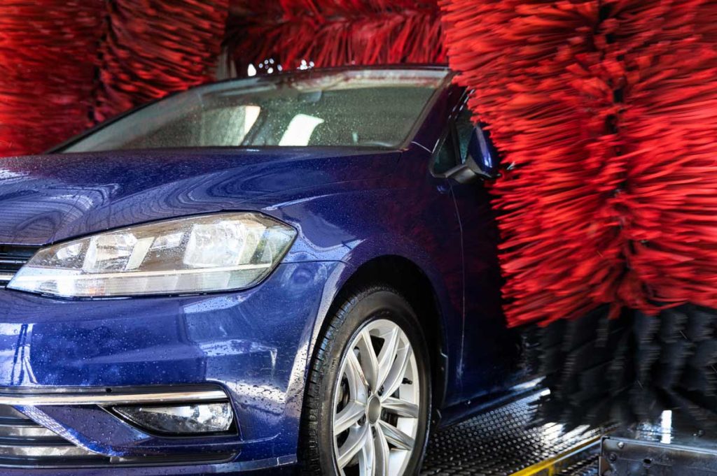 Unlimited car wash membership Katy TX delivers automated brush wash for blue car with deep clean and water-efficient system