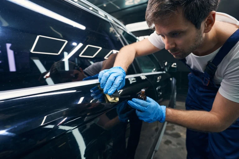 Skilled detailer applying protective coat to SUV paint. We offer the Best Car Wash in Katy TX for all detailing needs.